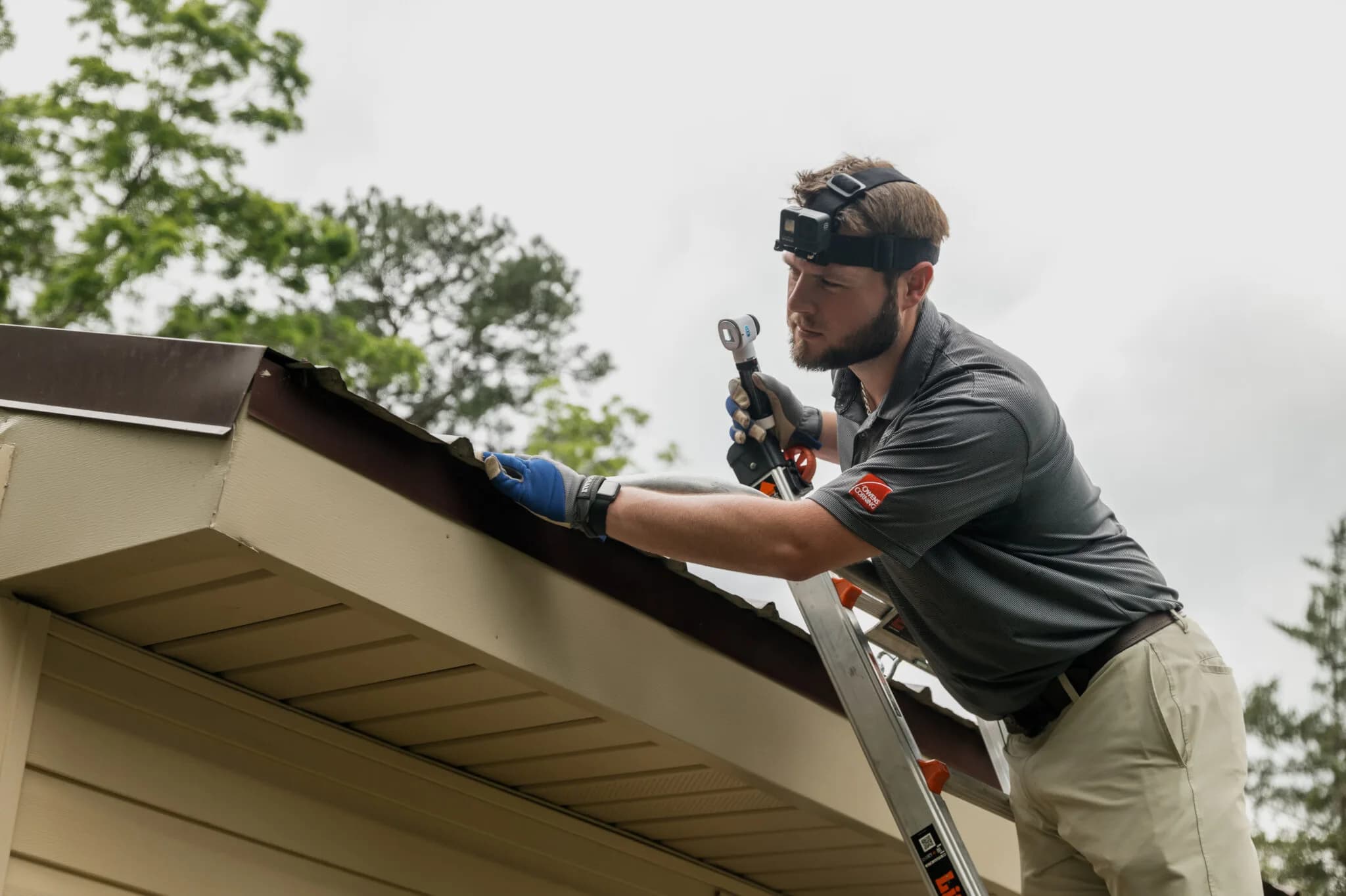 Strength Roofing & Siding crew member working on a roof edge
