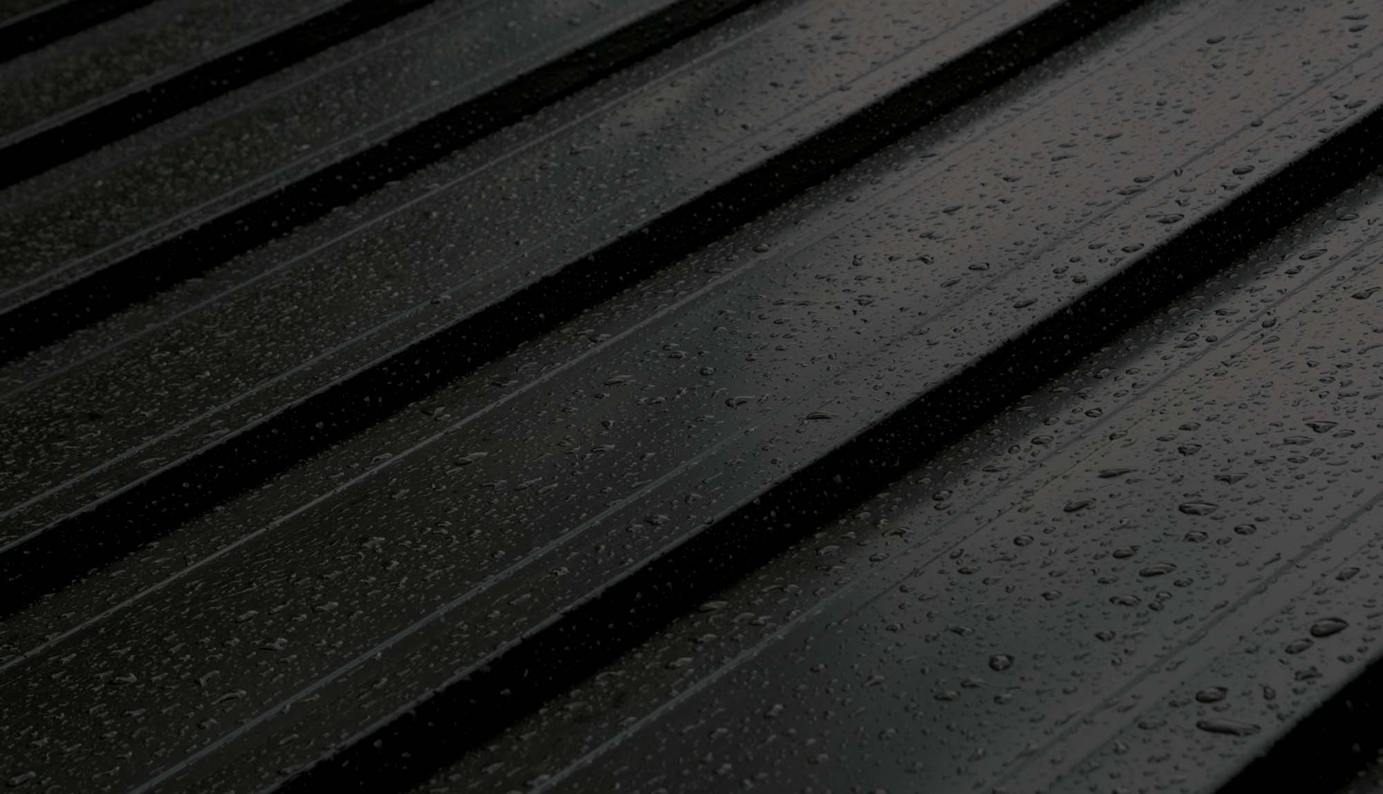 A metal roof with rain drops on it