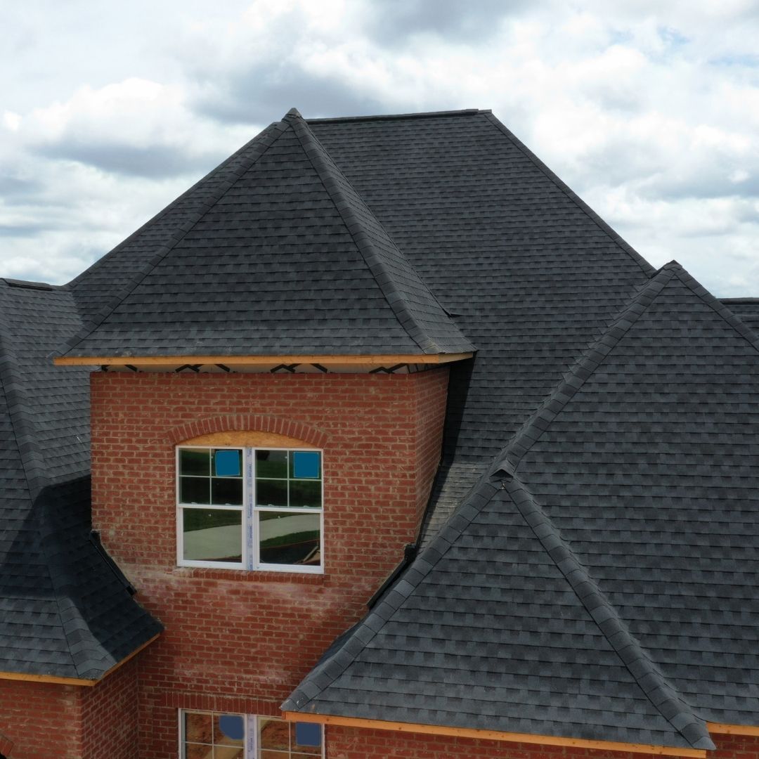 a view of the roof of a brick home