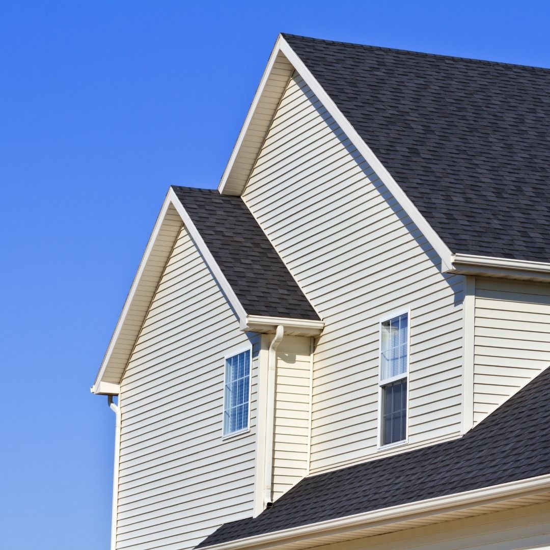 looking at the siding and roof of a home