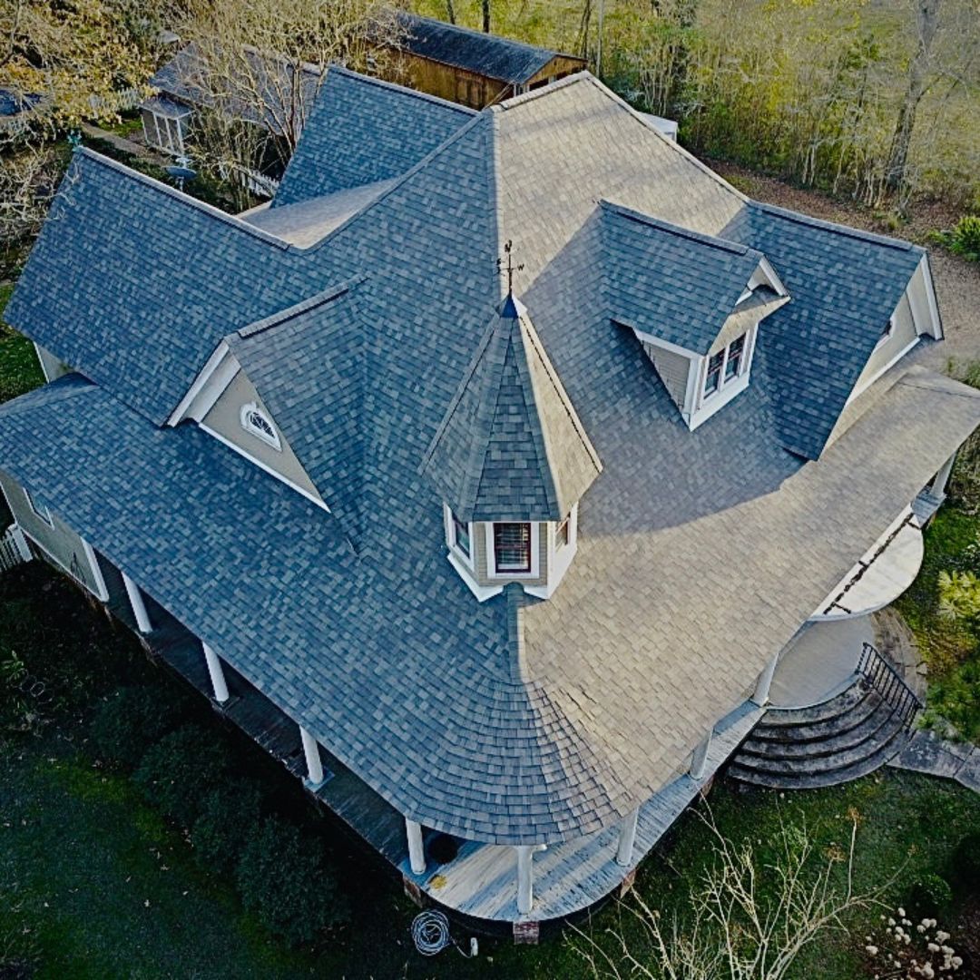 Large house with gray shingle roof