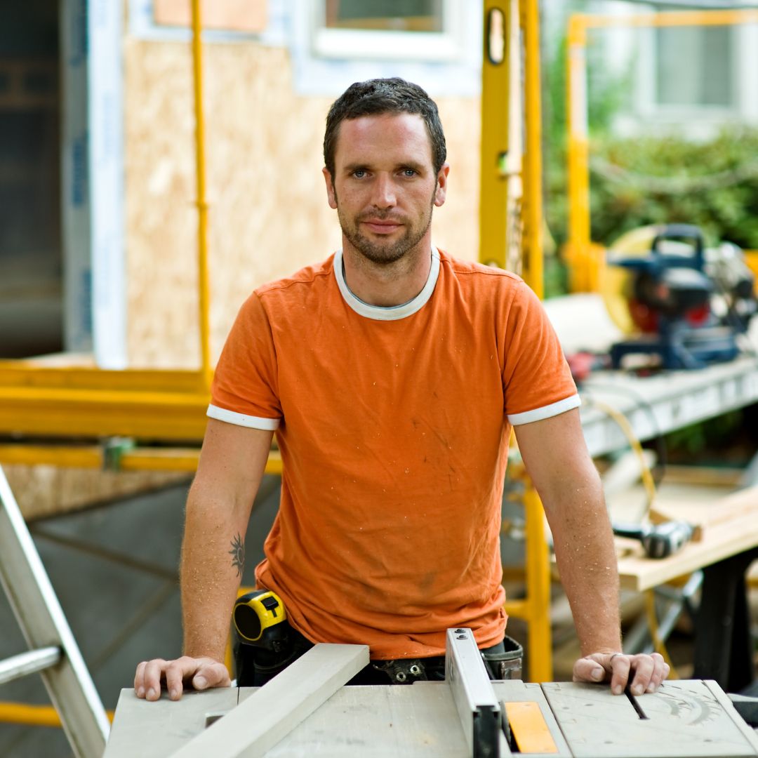 person in orange shirt on construction site