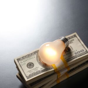 Stack of money and a lightbulb