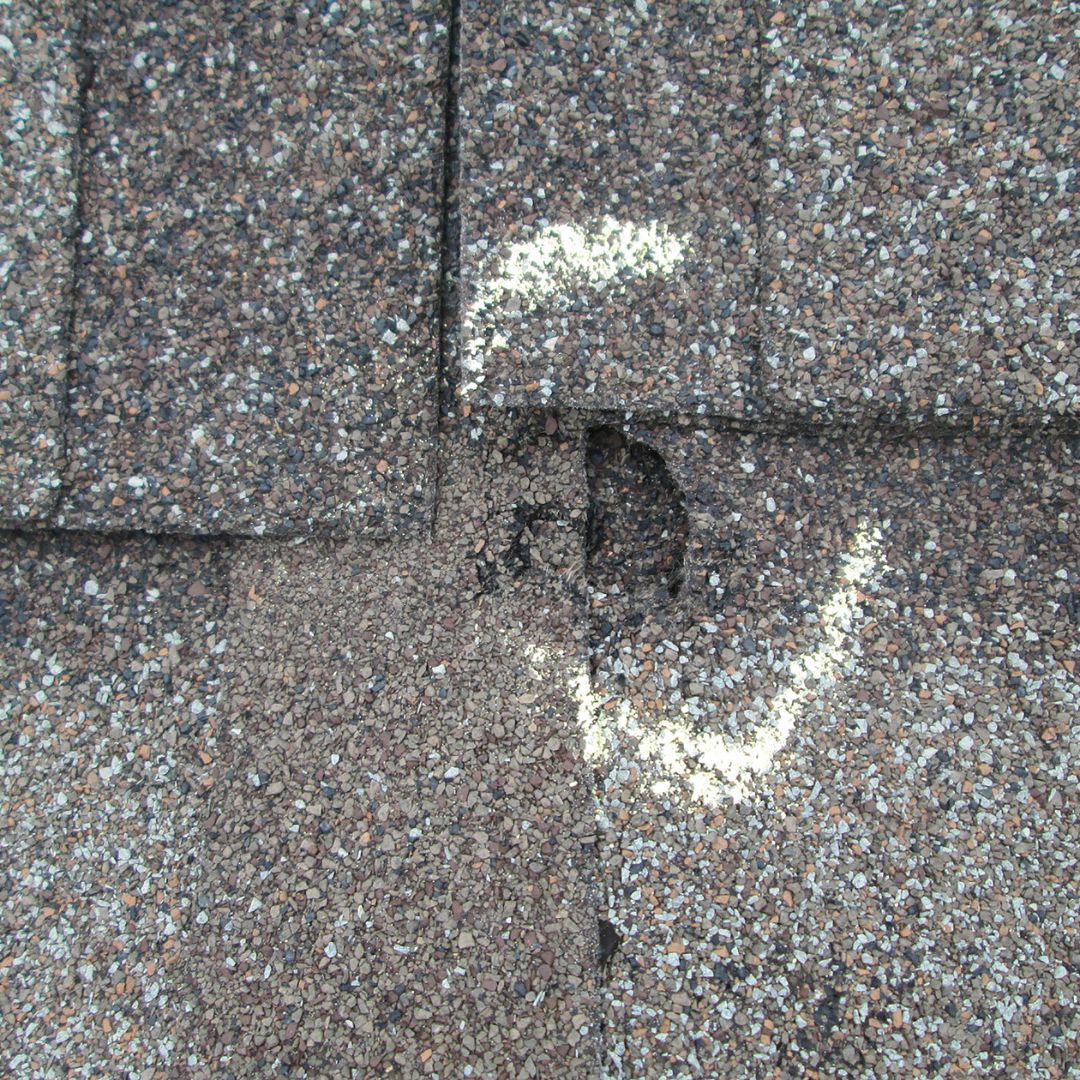 asphalt shingles with marked hail damage