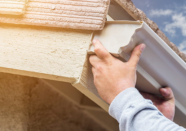 man installing gutters