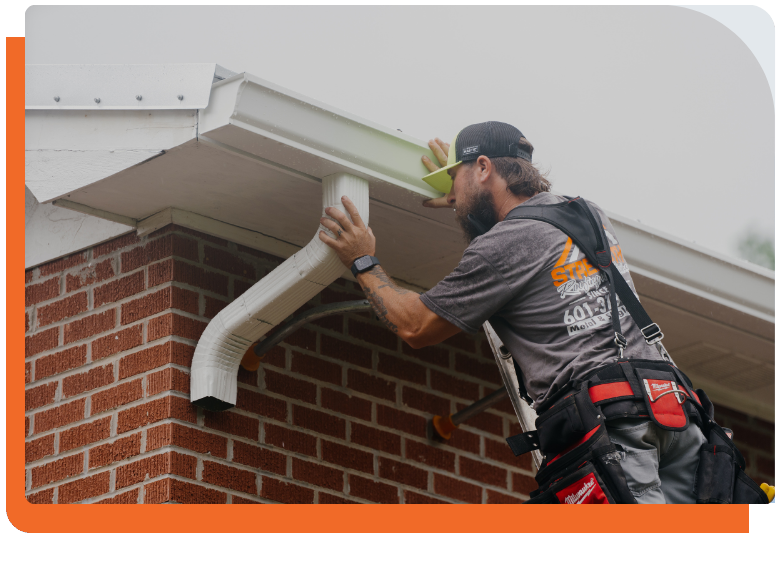 Strength Roofing & Siding worker working on gutters